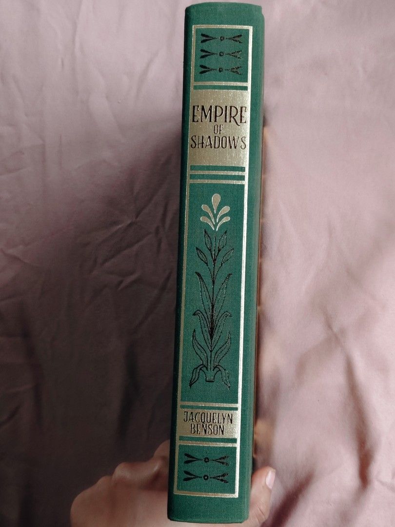 Empire of Shadows - Signed Special Edition (Category: Storybooks) located in Batangas. Submitted by eliza.reads.and.rehomes (Listing ID 1461343606, Image 2). Description: MOP: GCASH MOD: J&T EXPRESS ON HAND Signed -Green cloth mercerized cotton binding featuring an original design with gold and black foil stamping. -Rough-cut deckled page edges, a built-in gold ribbon bookmark, and custom patterned endpapers. - Includes Victorian-style black-and-
