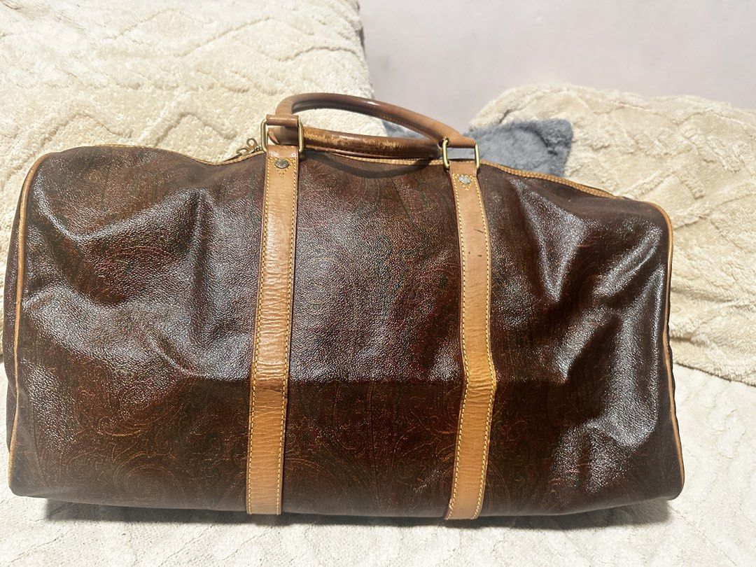 ETRO Milano Duffel Bag (Category: Luxury Bags & Wallets) located in Makati City. Submitted by travel.pasabuy (Listing ID 1461532954, Image 3). Description: - Classic Authentic ETRO duffel bag - Iconic paisley print on dark brown background - Leather trim and handles (shows some wear) - Functional zippers - Includes colorful letter keychain - Ideal for weekend trips or stylish carry-on.