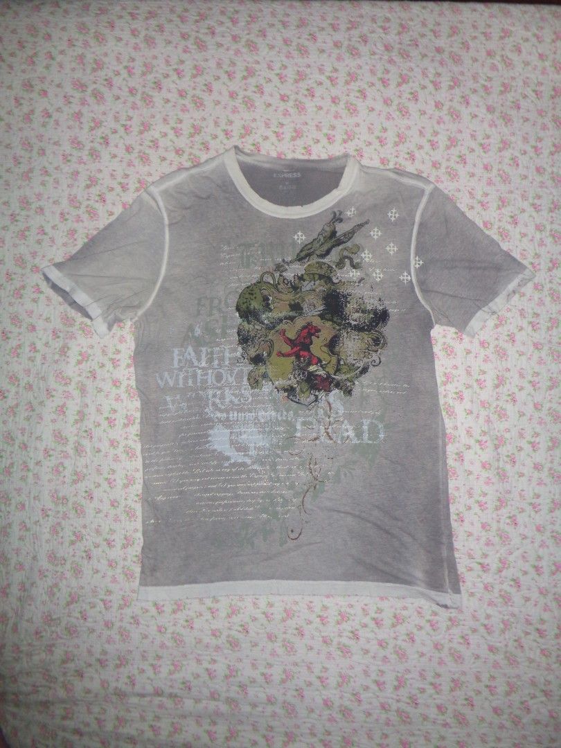 EXPRESS Distressed Graphic Tee (Category: Tshirts & Polo Shirts ) located in Batangas. Submitted by gelidium_lloyd (Listing ID 1461557879, Image 1). Description: - EXPRESS Grey Graphic Tee - Size: Medium (M) - Features a cool crest design with text details - Distressed hem and neckline for a worn-in look - Lightweight material, ideal for casual outfits.