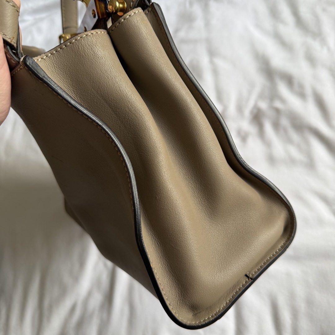 Fendi Peekaboo (Category: Luxury Bags & Wallets) located in Manila. Submitted by usetheoxfordcomma (Listing ID 1461484446, Image 3). Description: One side of the bag and the top handle have light cat scratches Bag is in otherwise great shape Comes with dust bag, strap, and paper bag.