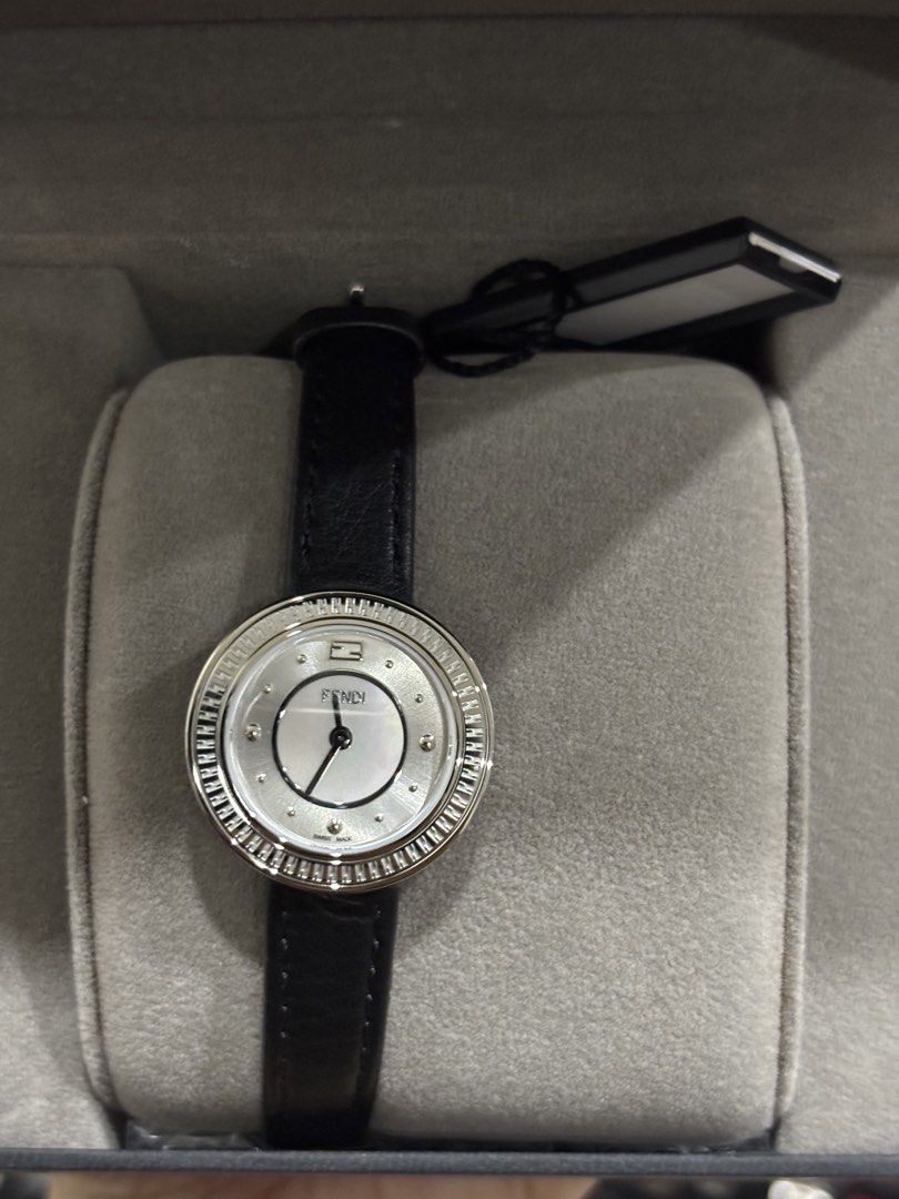 Fendi Watch with Leather Strap and Crystal Bezel (Category: Women's Watches) located in Malabon City. Submitted by everythingpreloveddd (Listing ID 1461329984, Image 1). Description: - Authentic Fendi Watch - White Mother-of-Pearl Dial - Silver-Tone Case - Crystal-Embellished Bezel - Black Leather Strap - Includes Original Fendi Box - Versatile for dressing up or everyday wear.