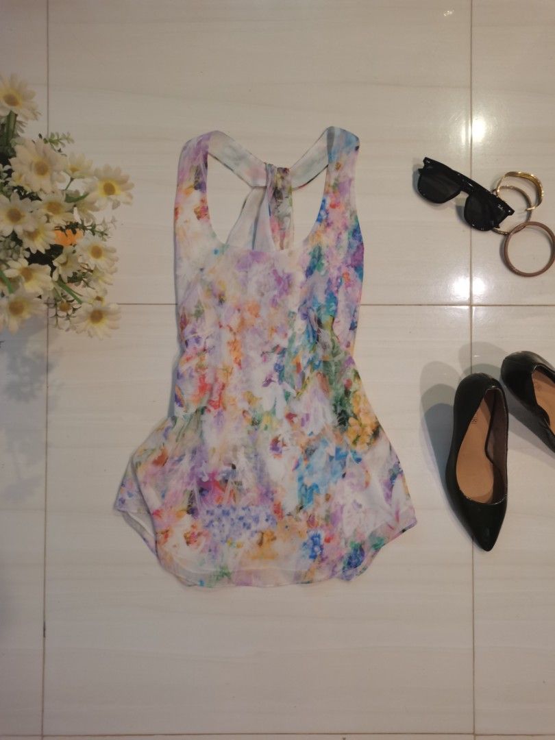 Floral Print Racerback Tank Top (Category: Sleeveless) located in Dipolog. Submitted by true.brclo_thing (Listing ID 1461442456, Image 2). Description: - Lightweight tank top - Colorful abstract floral print - Racerback design with back tie detail - Flowy and comfortable fabric - Versatile for casual wear or layering - Pairs well with jeans or shorts.
