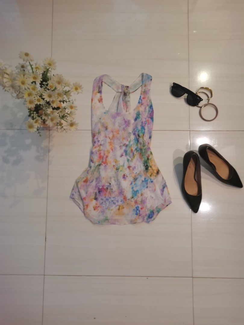 Floral Print Racerback Tank Top (Category: Sleeveless) located in Dipolog. Submitted by true.brclo_thing (Listing ID 1461442456, Image 1). Description: - Lightweight tank top - Colorful abstract floral print - Racerback design with back tie detail - Flowy and comfortable fabric - Versatile for casual wear or layering - Pairs well with jeans or shorts.
