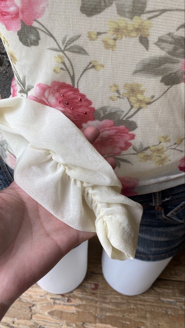 Floral Turtleneck Top (Category: Longsleeves) located in Davao. Submitted by calli_2219 (Listing ID 1461560731, Image 3). Description: - White turtleneck top - Pink and yellow floral print - ruffled cuffs - Scattered rhinestone details on floral design - Button closure at the back with keyhole cutout - Versatile: pair with jeans or a skirt for a chic look.
