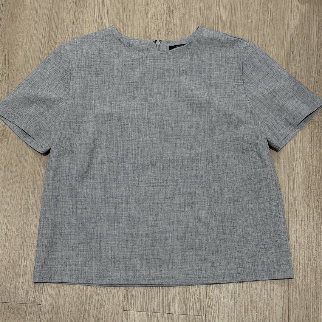 Forever 21 Grey Textured Short Sleeve Top Size S (Category: Blouses) located in Manila. Submitted by sg.21 (Listing ID 1461458593, Image 1). Description: - Forever 21 grey short sleeve top - Textured fabric - Zipper closure at the back - Small pen mark on the front (please check photos for details) Armpit 18” Length 21”.