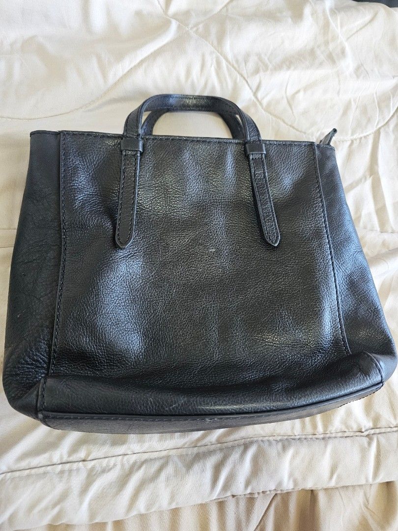 Fossil Camelia Black Leather Small Handbag (Category: Luxury Bags & Wallets) located in Antipolo. Submitted by miss.rl (Listing ID 1461347757, Image 1). Description: - Brand: Fossil - Material: Black Leather - Features: Top handles, main zippered compartment - Interior: Clean with Fossil branding - Some chipping in exterior as seen on photos - Restored handle with genuine leather Ideal for: Everyday use .