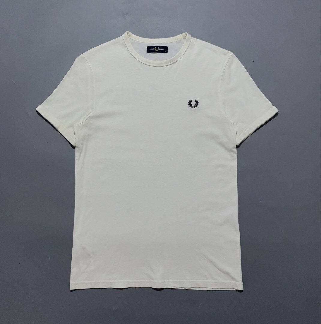 Fred Perry White Tee (Category: Activewear) located in Mabalacat. Submitted by thrift_trap (Listing ID 1461529291, Image 1). Description: Dimes: W17 x L26 (Size: XS on tag) Condition: Good Issue (s): Minimal stain & repaired 2 pinhole (unnoticeable) Color rate: 9/10 Complete tags🏷️ Color may vary due lighting‼️.