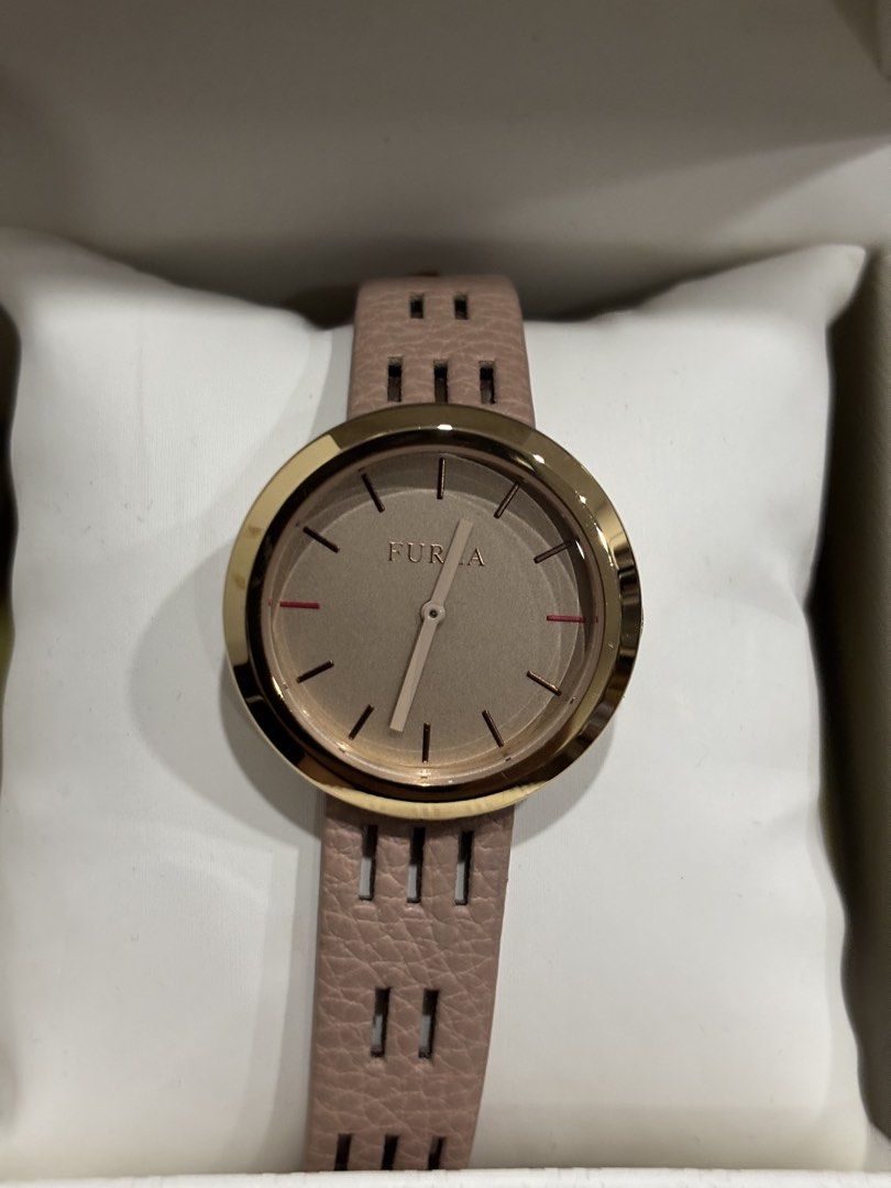 Furla Watch Rose Gold Pink Strap (Category: Women's Watches) located in Malabon City. Submitted by everythingpreloveddd (Listing ID 1461329951, Image 1). Description: - Elegant Furla watch - Rose gold bezel - Light pink strap with stylish cut-out details - Neutral beige dial with simple hour markers - Comes with original Furla box - Versatile for everyday or special occasions.