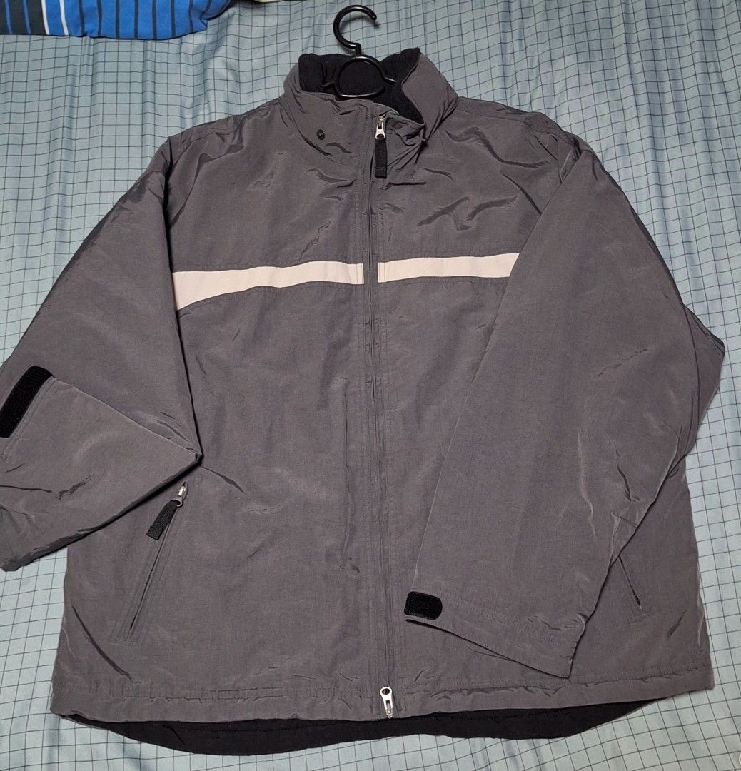 GAP Grey & Black Zip-Up Jacket (Category: Coats, Jackets and Outerwear) located in Manila. Submitted by ags028705 (Listing ID 1460916236, Image 1). Description: - Grey zip-up jacket from GAP - Black inner lining and sleeves - Features zippered pockets on the front - White stripe detail down the front and across the back - Ideal for layering and casual wear.