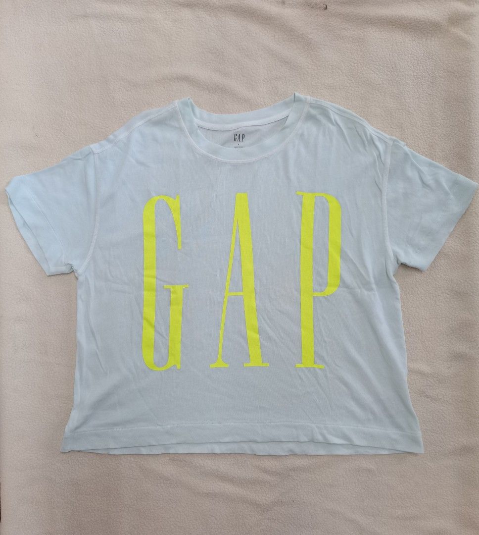 GAP short-sleeve graphic t-shirt. (Category: Shirts) located in Santa Cruz. Submitted by oddpenguin-4575 (Listing ID 1461523419, Image 2). Description: 📌.....P L E A S E R E A D..... 📌measurement:Laid flat Sh-20.5"/Sleeve-7"/Chest-17.5"/Lenght-23"/armhole-7"/armpit-8.5" 📌size:this shirt is a Filipino Women's Size Small (S), 📌color-10/10 📌Brand: GAP 📌Pattern/Style: Solid light mint green (or very pale blue/aqua) with a bold, oversized yellow