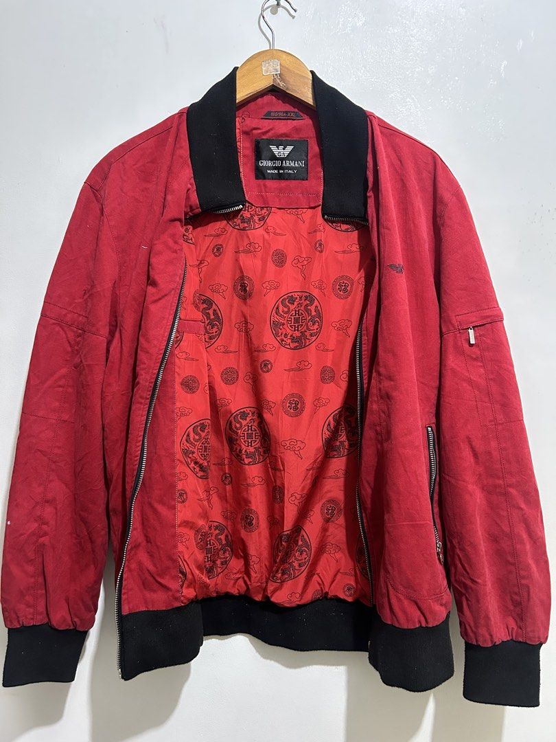 Giorgio Armani Red Bomber Jacket (Category: Coats, Jackets and Outerwear) located in Calbayog City. Submitted by thrift.bucks101 (Listing ID 1461406206, Image 2). Description: - Authentic Giorgio Armani bomber jacket - Color: Red with black collar and cuffs - Features classic Armani eagle logo embroidered on chest - Zipper closure with unique pull tab - Inner lining with cool Asian-inspired pattern - Made in Italy - Size: XXL.