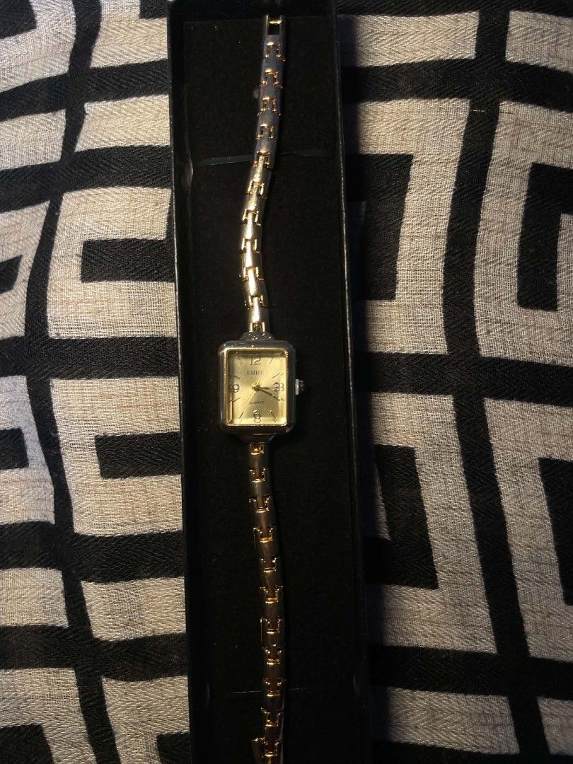 Gold Tone Square Face Watch (Category: Women's Watches) located in Impasugong. Submitted by gresha_closets (Listing ID 1461376475, Image 1). Description: - Gold tone watch - Square face - Classic link band - Simple and timeless design - Perfect for everyday or dressing up - Includes a black presentation box.