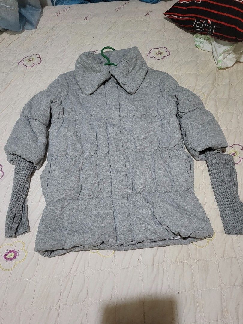 Grey Puffer Jacket with Knit Cuffs and Collar (Category: Coats, Jackets and Outerwear) located in Manila. Submitted by calmmountain.887b60 (Listing ID 1461335555, Image 1). Description: - Grey puffer jacket - Stand-up collar - Ribbed knit cuffs - Front button closure - Visible front pockets - Ideal for cooler weather - Comfortable and warm.