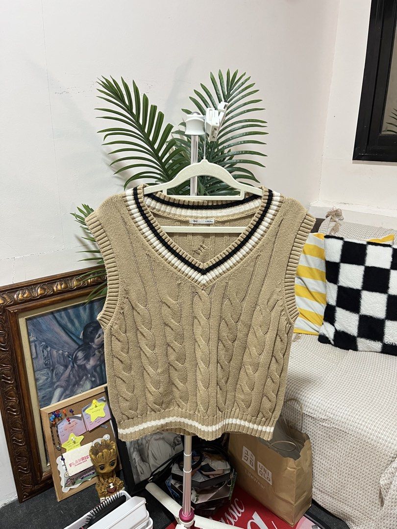GU Tilden Cable Knit Vest (Category: Sleeveless) located in Daet. Submitted by kathleenj_penguin (Listing ID 1461529566, Image 1). Description: - Cute cable knit sweater vest - Brand: GU - Color: Beige with white and black striped trim - Style: Sleeveless, V-neck - Versatile for layering over shirts or dresses - Size: M-L - Made in Bangladesh.
