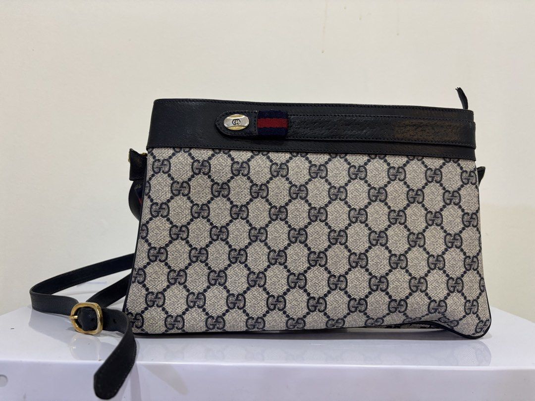 Gucci Monogram Shoulder Bag (Category: Luxury Bags & Wallets) located in Malabon City. Submitted by everythingpreloveddd (Listing ID 1461484313, Image 1). Description: - Classic Gucci shoulder bag - Iconic GG monogram pattern - Black leather trim and strap - Gold hardware details - Small red and blue stripe detail on front flap - Ideal for everyday use.