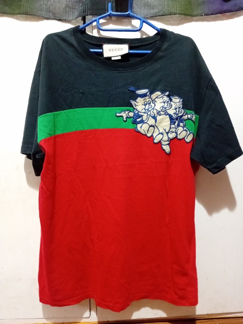 Gucci x Disney T-shirt (Category: Tshirts & Polo Shirts ) located in Iloilo. Submitted by luckytiger.c90343 (Listing ID 1461408010, Image 1). Description: - Authentic Gucci T-shirt featuring a fun Disney character graphic. - Stylish color block design in red, green, and black. - Made in Italy for premium quality. - Size S, perfect for a snug fit. - A must-have for any Gucci and Disney enthusiast!.