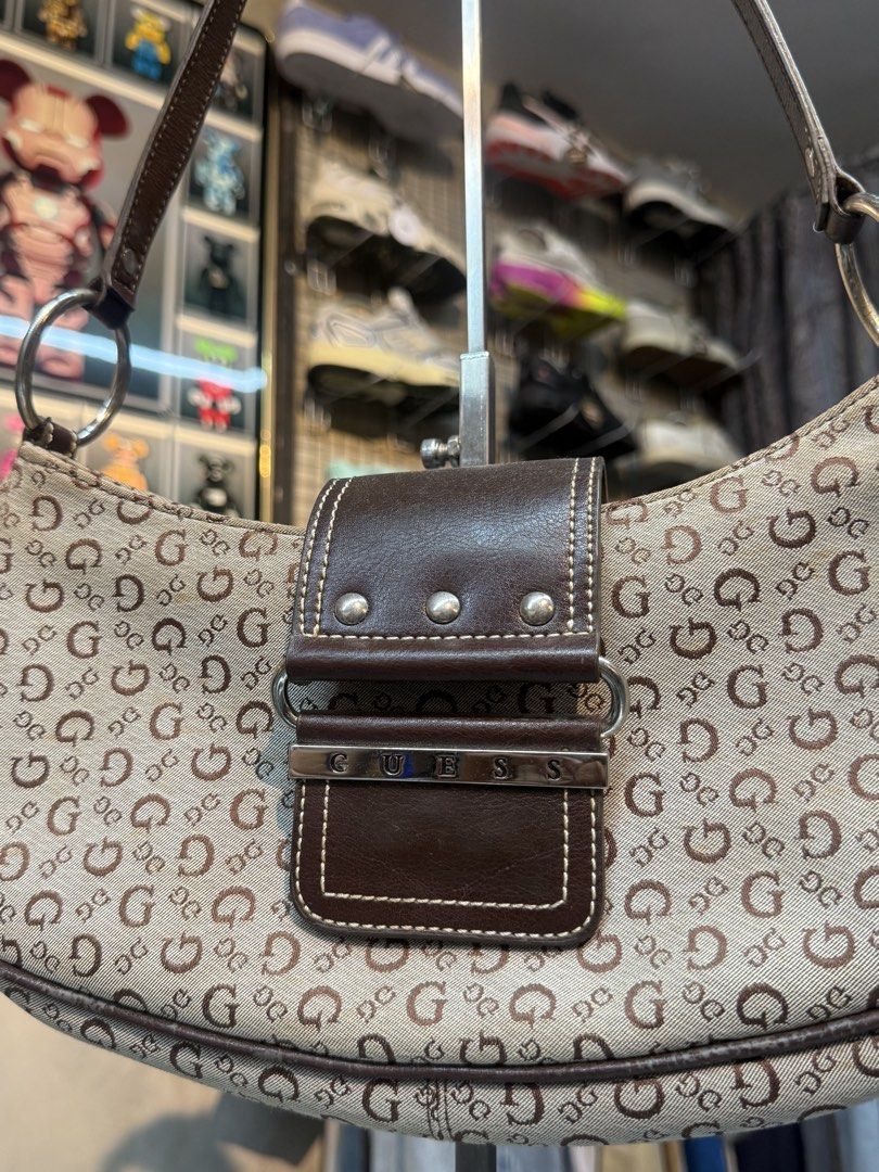 Guess Monogram Shoulder Bag (Category: Shoulder Bags) located in Legazpi City. Submitted by keantuttt (Listing ID 1461518705, Image 2). Description: - Classic Guess monogram shoulder bag - Color: Brown and beige GG pattern - Material: Leather trim and strap - Closure: Zipper with front flap pocket - Interior: Zippered pocket (note: interior has a stain) - Style: Great everyday bag.