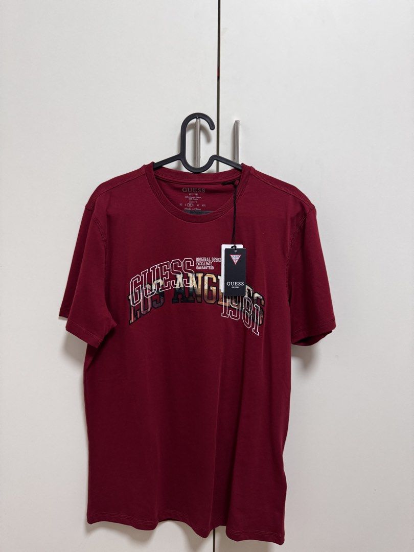 Guess T-shirt Size M (Category: Tshirts & Polo Shirts ) located in Santa Rosa. Submitted by techandfashionfinds (Listing ID 1461511551, Image 1). Description: AUTHENTIC!!! - Guess T-Shirt - Size: Medium (M) - Color: Deep Red / Maroon - Material: Organic Cotton - Style: Casual Wear Rfs: di kasya.
