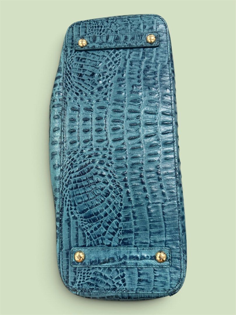 Guy Laroche Teal Crocodile Embossed Leather Handbag (Category: Luxury Bags & Wallets) located in Lapu Lapu. Submitted by warmwhale.be136e (Listing ID 1461486601, Image 3). Description: - Stylish teal handbag with a luxurious crocodile embossed finish. - Secure buckle closure on the front flap. - Comfortable top handle for easy carrying. - Detachable shoulder strap for versatile wear. - Convenient interior zippered pocket for essentials. - Elegant