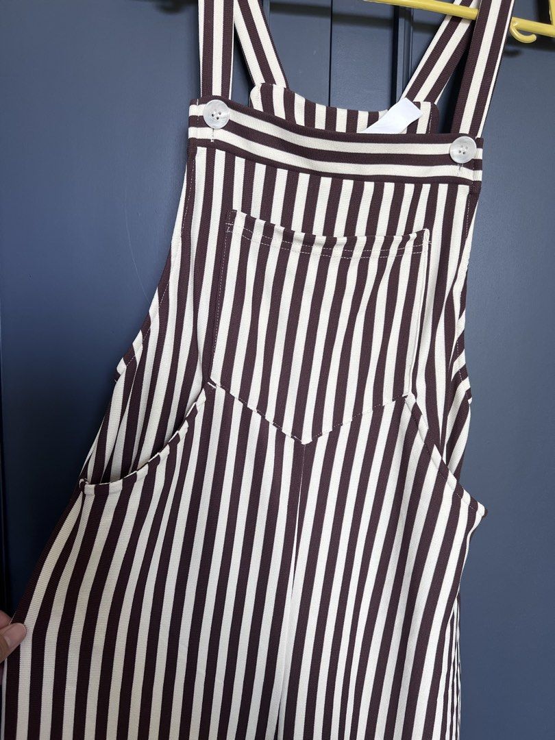 Halara Striped Jumpsuit XS (Category: Jumpsuits) located in Pulilan. Submitted by chibimoon81 (Listing ID 1461406155, Image 2). Description: - Halara brown and white striped jumpsuit - Size XS - Ribbed fabric - Functional pockets - Adjustable straps - Ideal for casual wear - Versatile for layering with a t-shirt.