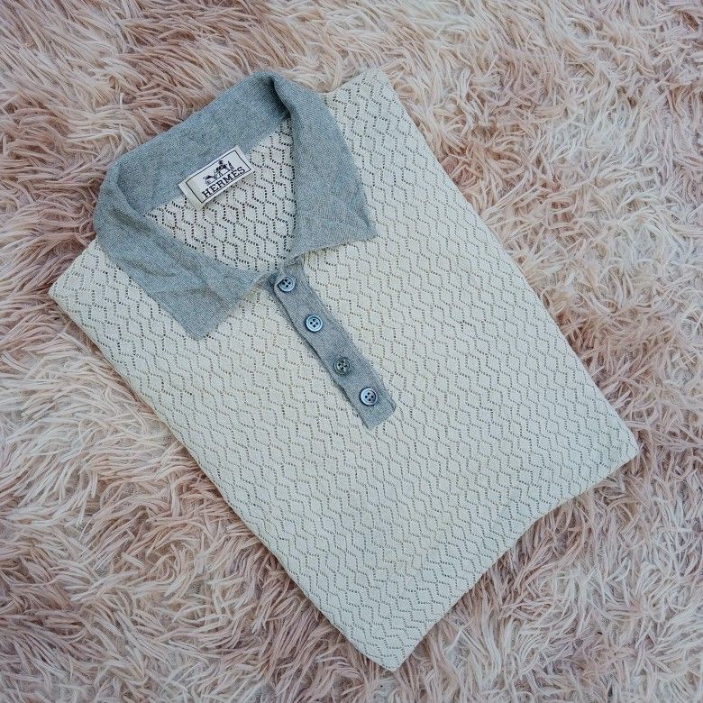 Hermes Knit Polo Shirt (Category: Tshirts & Polo Shirts ) located in Boston. Submitted by johnpaulvi30029 (Listing ID 1461396387, Image 1). Description: - Hermes knit polo shirt - Color: Cream with grey collar and cuffs - Design: Diamond pattern knit - Features: Three-button placket - Style: Great for casual wear or layering - Fit: Looks good on.