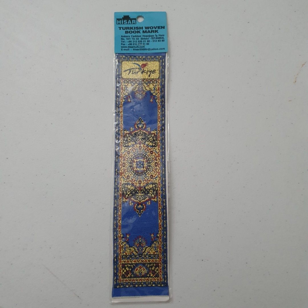 HISAR Turkish Woven Book Mark (Category: Stationery & School Supplies) located in Paranaque City. Submitted by cobien (Listing ID 1461538899, Image 1). Description: - Authentic HISAR Turkish woven bookmark - Beautiful blue and gold intricate pattern inspired by Turkish carpets - 'Türkiye' prominently displayed - Comes in original packaging - Ideal for book lovers or as a souvenir.
