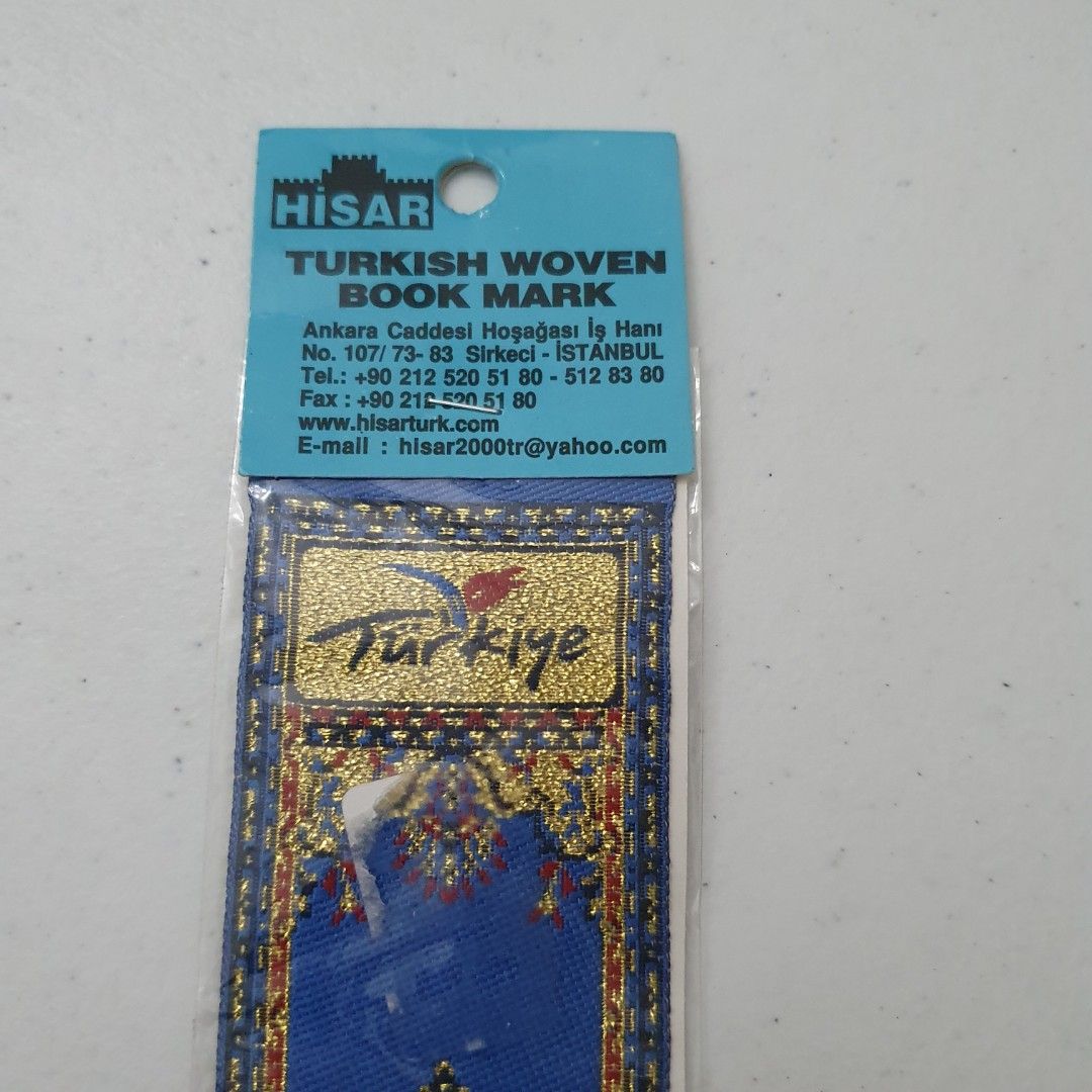 HISAR Turkish Woven Book Mark (Category: Stationery & School Supplies) located in Paranaque City. Submitted by cobien (Listing ID 1461538899, Image 3). Description: - Authentic HISAR Turkish woven bookmark - Beautiful blue and gold intricate pattern inspired by Turkish carpets - 'Türkiye' prominently displayed - Comes in original packaging - Ideal for book lovers or as a souvenir.