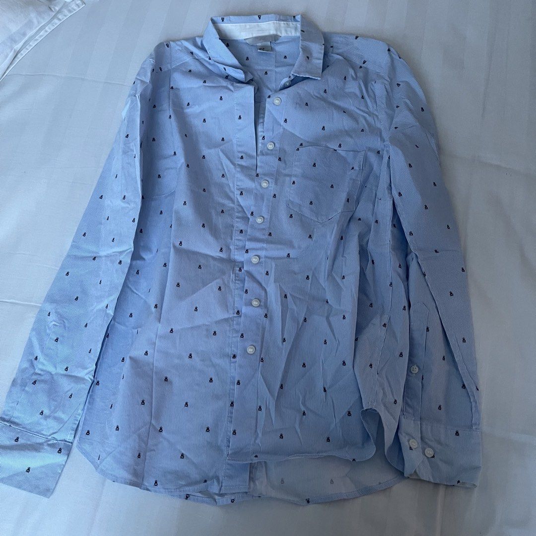 H&M Blue Striped Shirt with Bug Print (Category: Shirts) located in Muntinlupa City. Submitted by sza1123 (Listing ID 1461414413, Image 1). Description: - Light blue H&M button-up shirt - Subtle black bug pinstripe pattern - Long sleeves with button cuffs - Single chest pocket - Perfect for casual wear or layering.