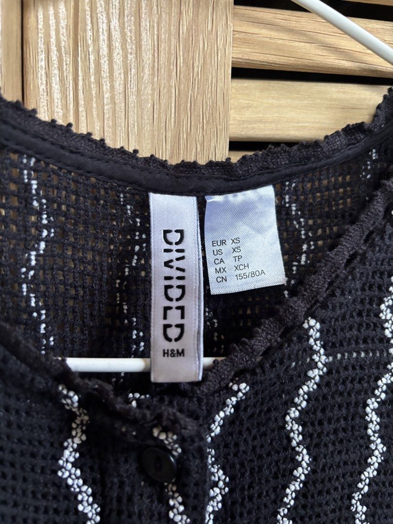 H&M Divided Black Crochet Button-Up Crop Top (Category: Others Tops) located in Antipolo. Submitted by jeremmeeldeleon (Listing ID 1461423587, Image 3). Description: - Brand: H&M Divided - Type: Crochet Crop Top - Size: XS - Features: Sleeveless, Button-up front - Design: Wavy white stripe pattern - Styling: Perfect for layering or wearing on its own - Occasion: Casual outings, nights with friends.
