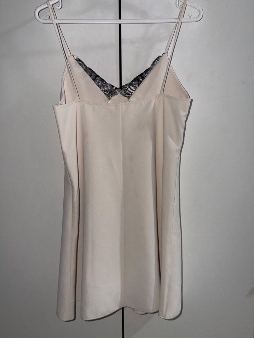 H&M Lace Trim Dress (Category: Dresses) located in Manila. Submitted by closetbykiks (Listing ID 1461463070, Image 3). Description: Size: Extra Small (EUR XS / US XS / CA TP / MX XCH / CN 155/80A) Colors Included: Off-White / Cream with Black Lace trim Style: Sleeveless slip mini dress with double shoulder straps and delicate black lace trim along the front V-neckline Fabric: Smooth woven satin/polyester blend Condition: Good pre-owned condition 