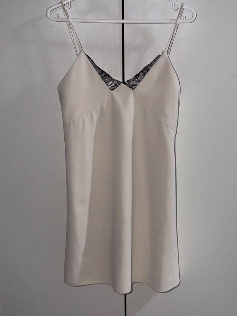 H&M Lace Trim Dress (Category: Dresses) located in Manila. Submitted by closetbykiks (Listing ID 1461463070, Image 2). Description: Size: Extra Small (EUR XS / US XS / CA TP / MX XCH / CN 155/80A) Colors Included: Off-White / Cream with Black Lace trim Style: Sleeveless slip mini dress with double shoulder straps and delicate black lace trim along the front V-neckline Fabric: Smooth woven satin/polyester blend Condition: Good pre-owned condition 