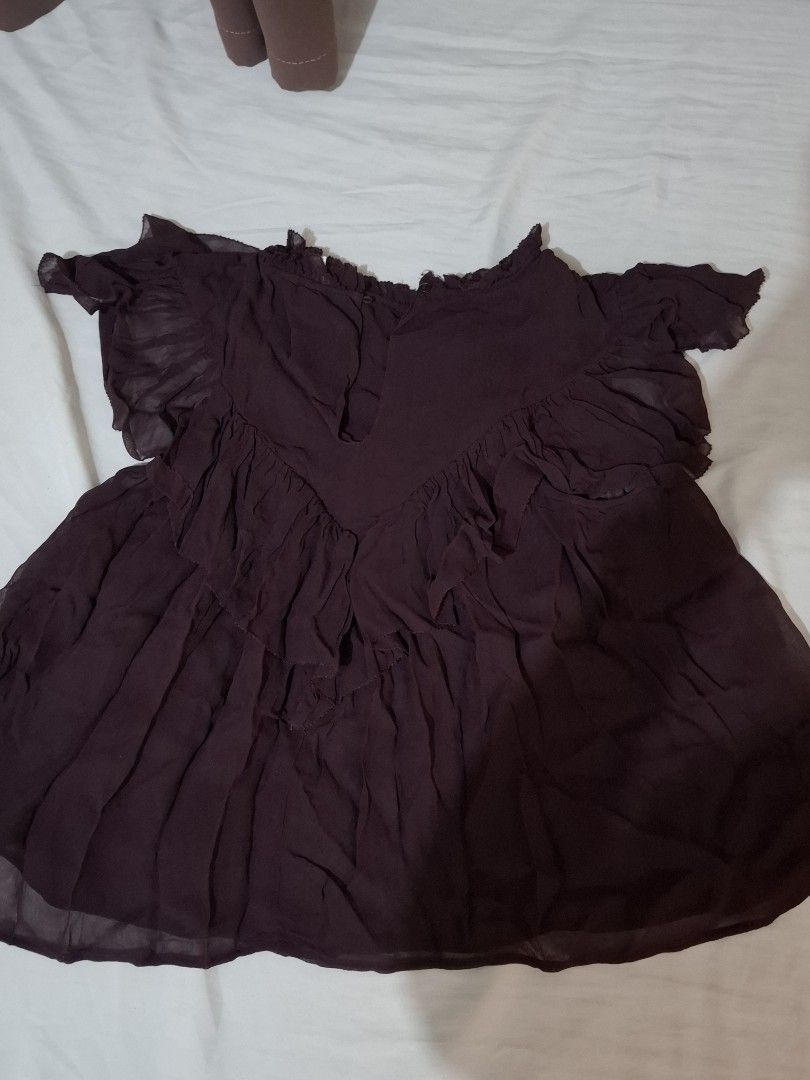 H&M Sheer Ruffle Top XS Plum Maroon (Category: Sleeveless) located in Taguig. Submitted by plnmrtz (Listing ID 1461522856, Image 3). Description: - Sheer plum purple top from H&M - Features ruffled neckline and hem - Shirred bust detail for a flattering fit - Short sleeves - Button closure at the back - Lightweight fabric, perfect for layering or warm weather - Worn only once - RFS: Decluttering .