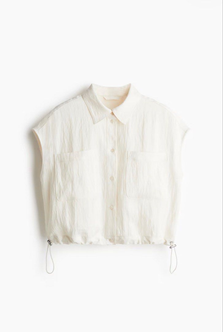 H&M White Cropped Shirt with Drawstring Hem (Category: Shirts) located in Iloilo. Submitted by dabyladaby2 (Listing ID 1461503102, Image 1). Description: - White cropped shirt from H&M - Sleeveless with collared neckline - Button-up front with two chest pockets - Adjustable drawstring hem - Made from a comfortable linen-blend fabric -once used.