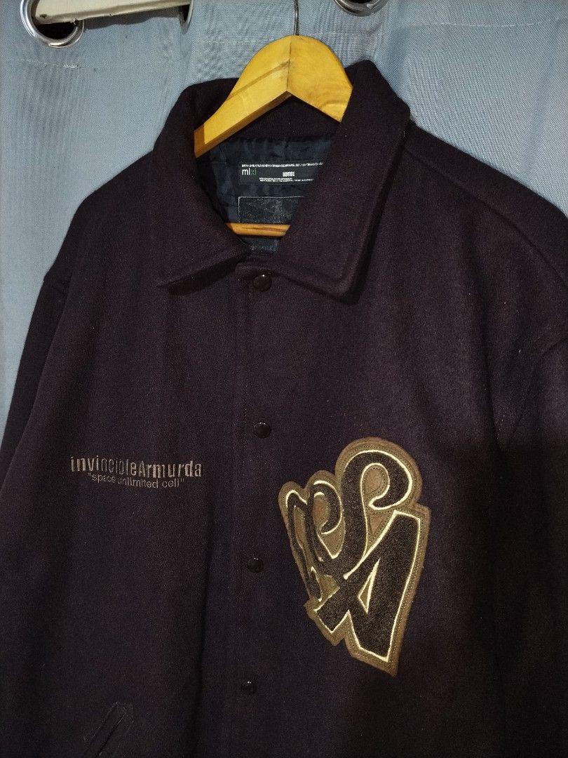 Invincible Armurda Japan Wool Jacket (Category: Coats, Jackets and Outerwear) located in Pasig City. Submitted by loveforlux_2025 (Listing ID 1461521269, Image 2). Description: - Dark brown varsity jacket from Invincible Armada. - Features "invincibleArmada" and "space unlimited cell" embroidery on the front. - Large embroidered "SA" logo on the right chest. - Button-up closure. - Includes pockets. - Ribbed cuffs and hem for a snug fit..