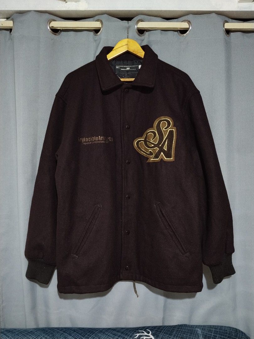Invincible Armurda Japan Wool Jacket (Category: Coats, Jackets and Outerwear) located in Pasig City. Submitted by loveforlux_2025 (Listing ID 1461521269, Image 1). Description: - Dark brown varsity jacket from Invincible Armada. - Features "invincibleArmada" and "space unlimited cell" embroidery on the front. - Large embroidered "SA" logo on the right chest. - Button-up closure. - Includes pockets. - Ribbed cuffs and hem for a snug fit..