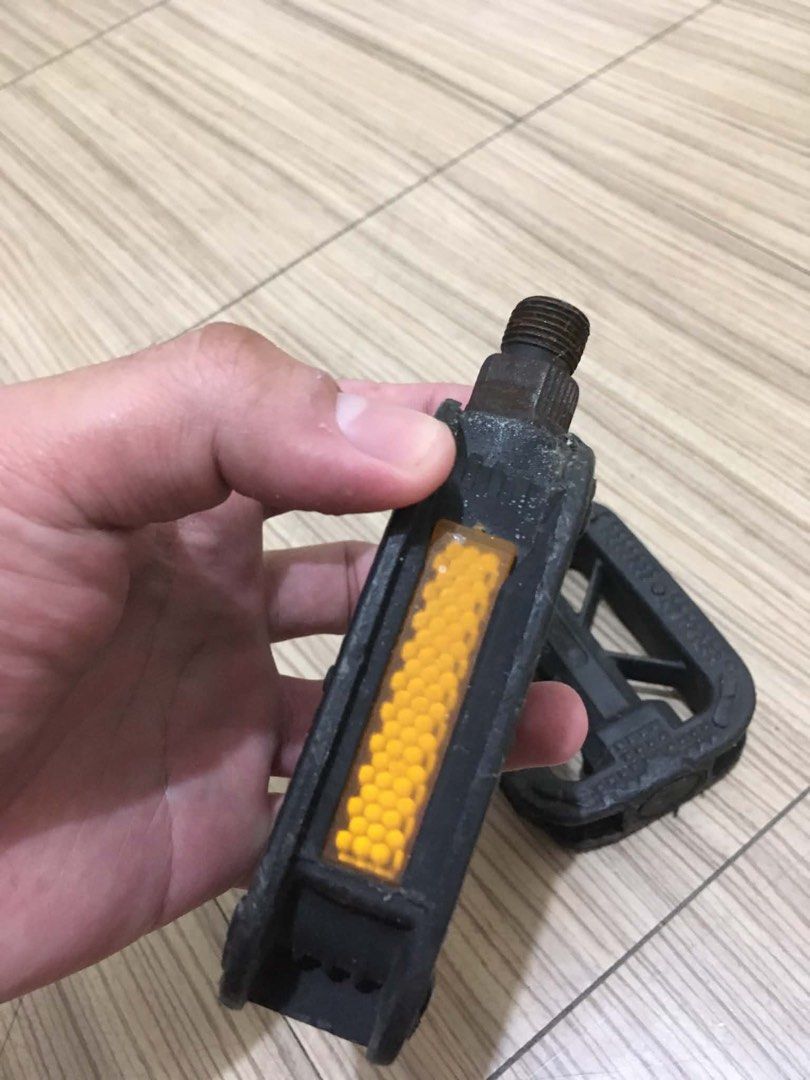 JAPANESSE BIKE PEDALS (Category: Bicycles) located in Makati City. Submitted by lilmissgirl (Listing ID 1461537692, Image 3). Description: JAPANESSE BIKE PEDALS AS IS WHAT YOU SEE IS WHAT YOU GET - Black bicycle pedals - Features orange reflectors on the sides - Standard threading, compatible with most bikes - Ideal for replacing old pedals or for new bike builds - Ready for immediate shipping.