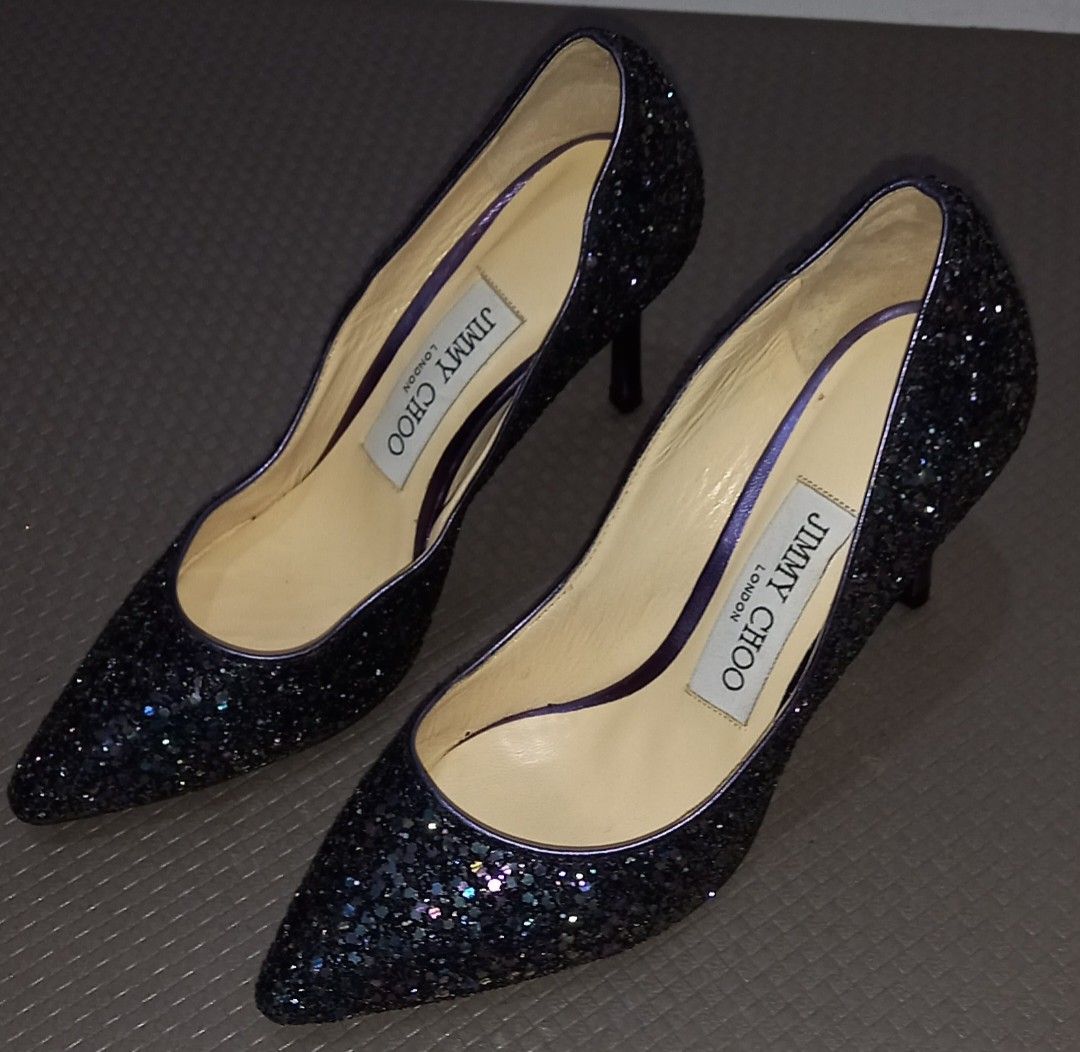 JIMMY CHOO Purple Glitter Heels Size 34 (Category: Heels) located in Cagayan de Oro. Submitted by edwardryan01984 (Listing ID 1461386121, Image 1). Description: - Brand: Jimmy Choo - Color: Dark purple glitter with purple trim and heel detail - Style: Pointed toe heels - Origin: Made in Italy - Size: 34 - Perfect for dressing up any outfit.