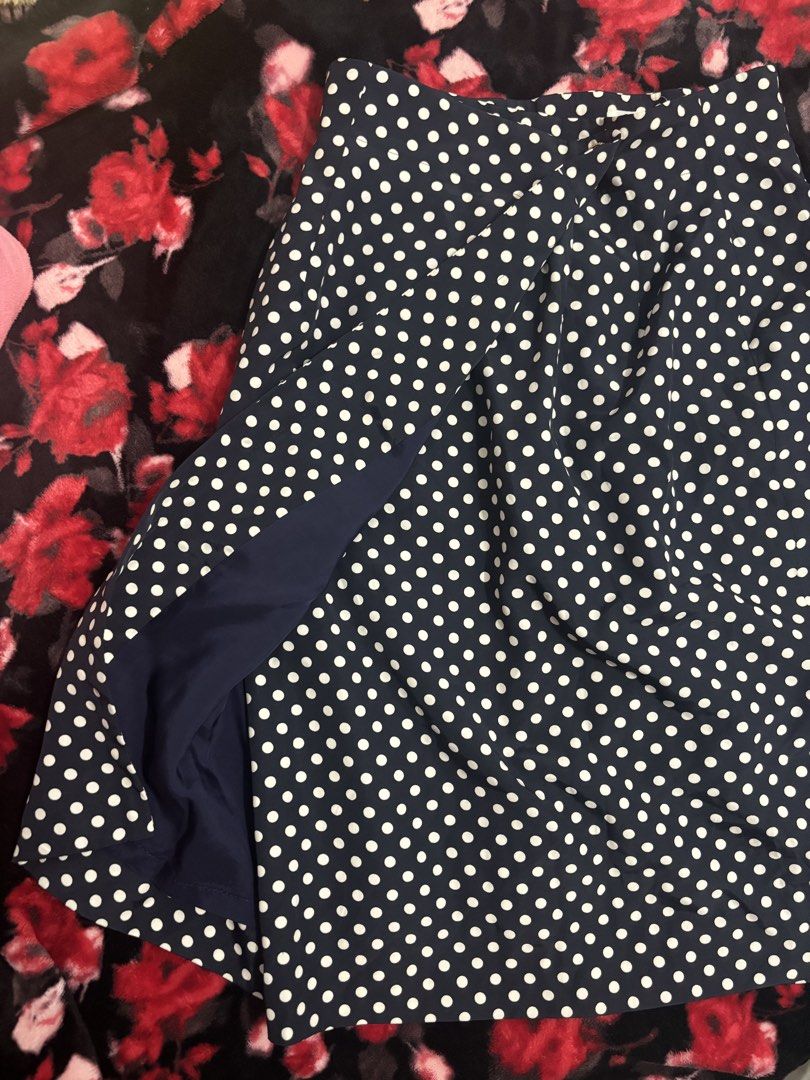 JOIE Navy Blue Polka Dot Skirt (Category: Skirts) located in Cavite. Submitted by raf.nomnom (Listing ID 1461400627, Image 2). Description: - Navy blue skirt with classic white polka dots - Elegant gold button closure at the waist - Unique dark blue panel detail on the side - Versatile for both casual outings and dressy events - Comfortable and fashionable design.