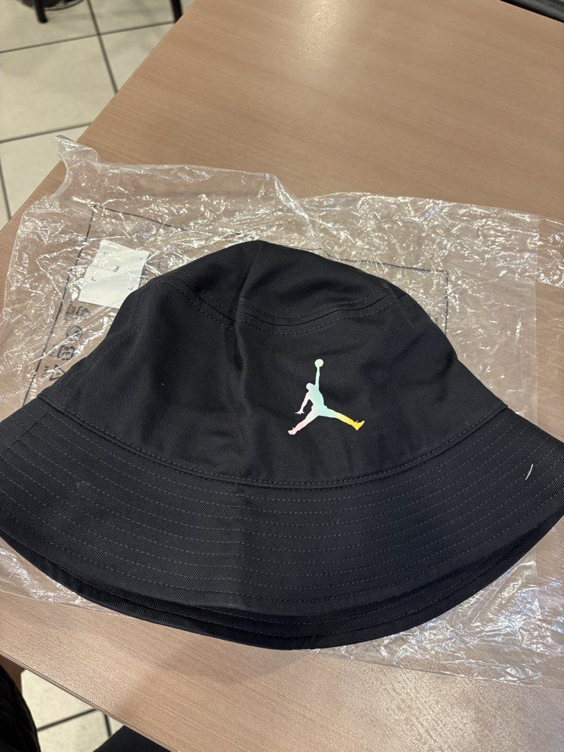 Jordan Bucket Hat - Black (Category: Caps & Hats) located in Manila. Submitted by lucky.beyaaa (Listing ID 1461374950, Image 1). Description: - Black Jordan bucket hat - Size: M - Iconic Jumpman logo with colorful gradient - "Move to Zero" and Nike branding on tag - 100% cotton - Ideal for sunny days and adding style to any outfit.