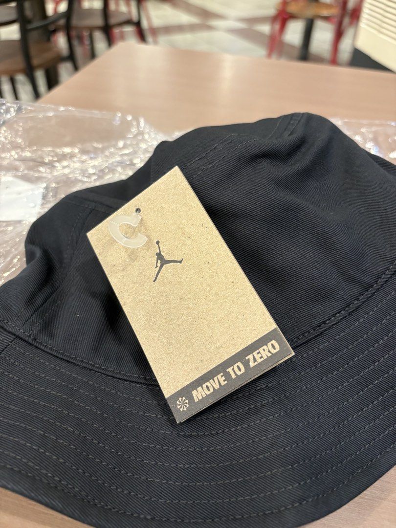Jordan Bucket Hat - Black (Category: Caps & Hats) located in Manila. Submitted by lucky.beyaaa (Listing ID 1461374950, Image 2). Description: - Black Jordan bucket hat - Size: M - Iconic Jumpman logo with colorful gradient - "Move to Zero" and Nike branding on tag - 100% cotton - Ideal for sunny days and adding style to any outfit.
