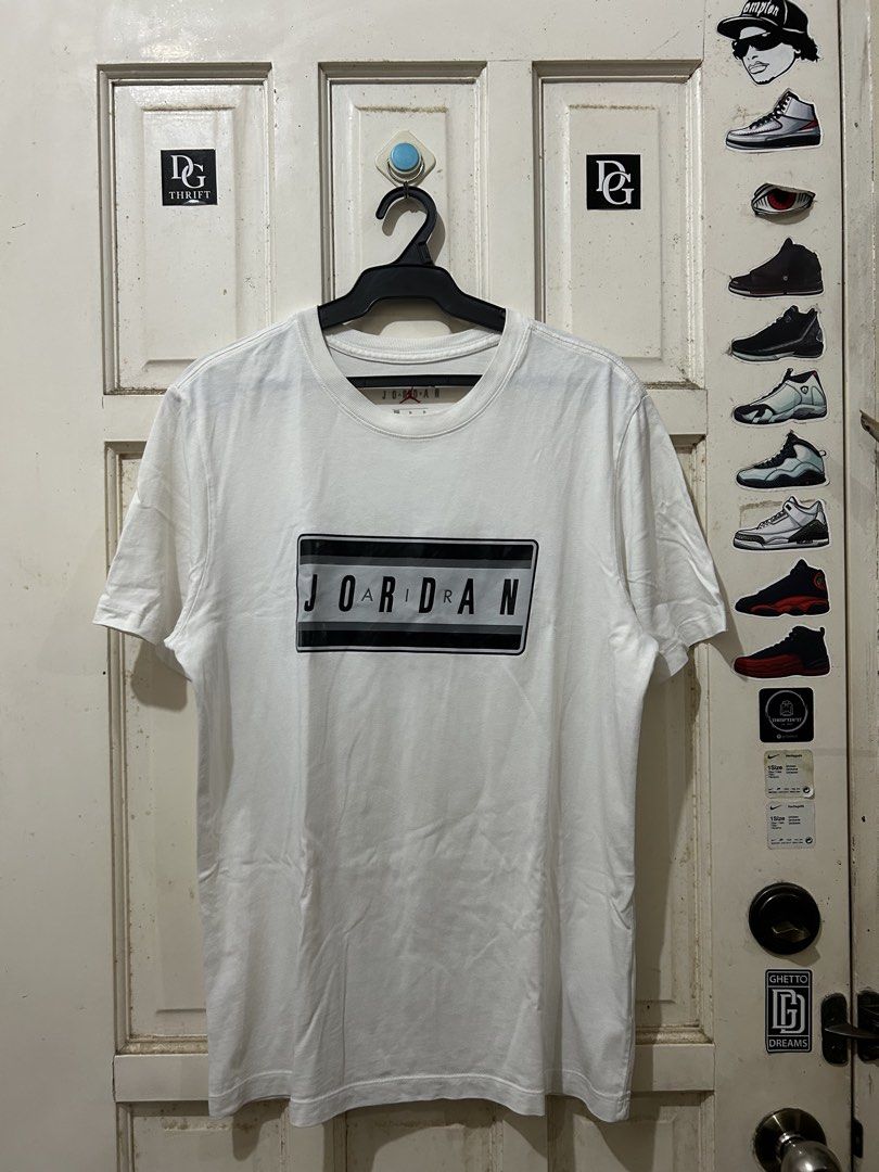 Jordan White T-Shirt (Category: Tshirts & Polo Shirts ) located in Pasay City. Submitted by deguzmanjay (Listing ID 1461514334, Image 1). Description: - Classic white Jordan t-shirt - Features a black and grey box logo on the front - Simple and versatile design - Ideal for everyday wear - Tag indicates size medium (fits like a typical medium).