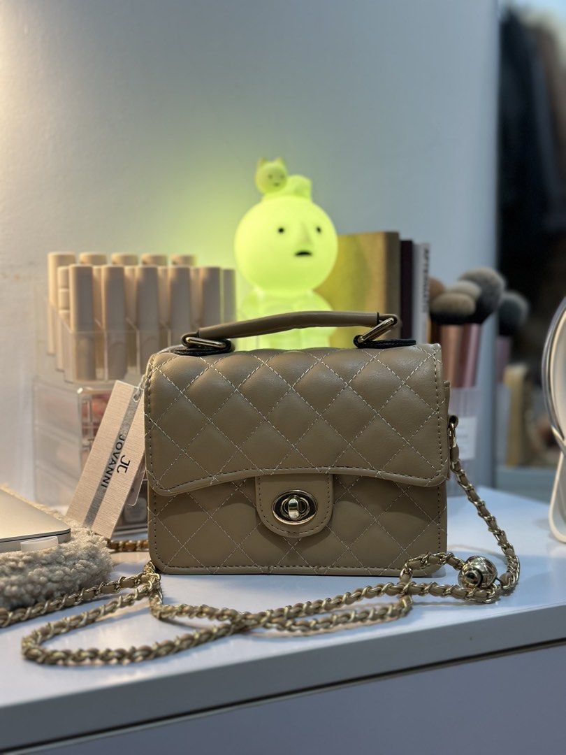 Jovanni Quilted Chain Bag (Category: Cross-body Bags) located in Manila. Submitted by tinne15 (Listing ID 1461526359, Image 3). Description: - Cute beige quilted bag - Adjustable gold chain strap and top handle - Interior zippered pocket - Comes with original tag - Ideal for going out or everyday use.