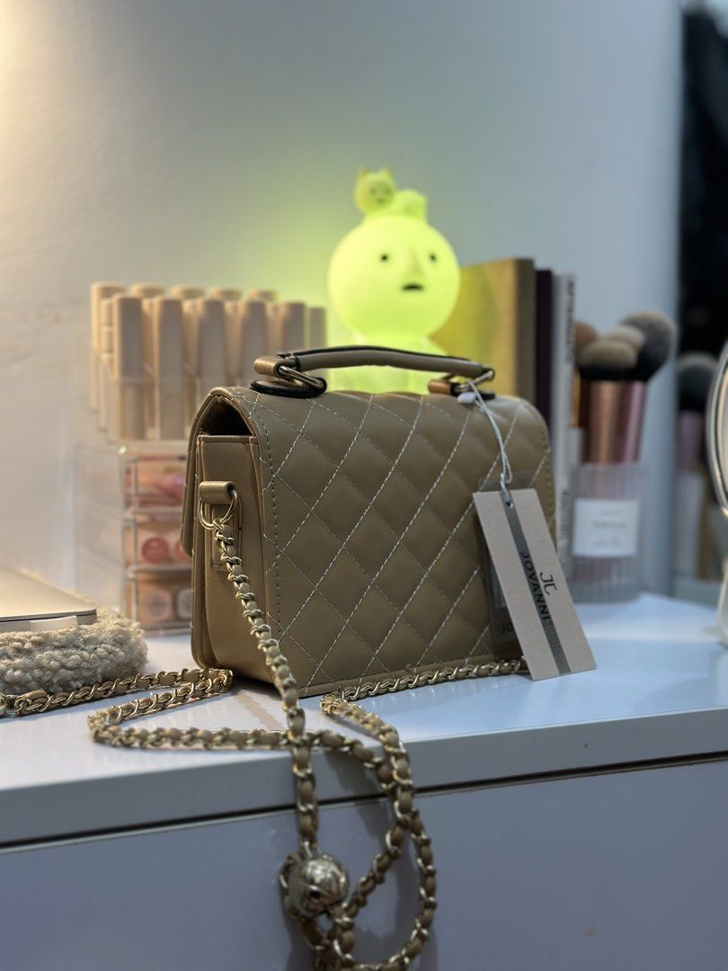 Jovanni Quilted Chain Bag (Category: Cross-body Bags) located in Manila. Submitted by tinne15 (Listing ID 1461526359, Image 2). Description: - Cute beige quilted bag - Adjustable gold chain strap and top handle - Interior zippered pocket - Comes with original tag - Ideal for going out or everyday use.