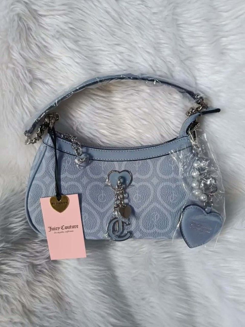 Juicy Couture Bubble Pop Shoulder Bag - Dusty Blue (Category: Shoulder Bags) located in Cavite. Submitted by mahthriftshop (Listing ID 1461489445, Image 1). Description: - Authentic Juicy Couture shoulder bag - Color: Dusty blue - All-over JC heart monogram pattern - Adorable heart and pearl charms included - Secure zipper closure - Interior lined with pink fabric - Brand new with original tags attached.