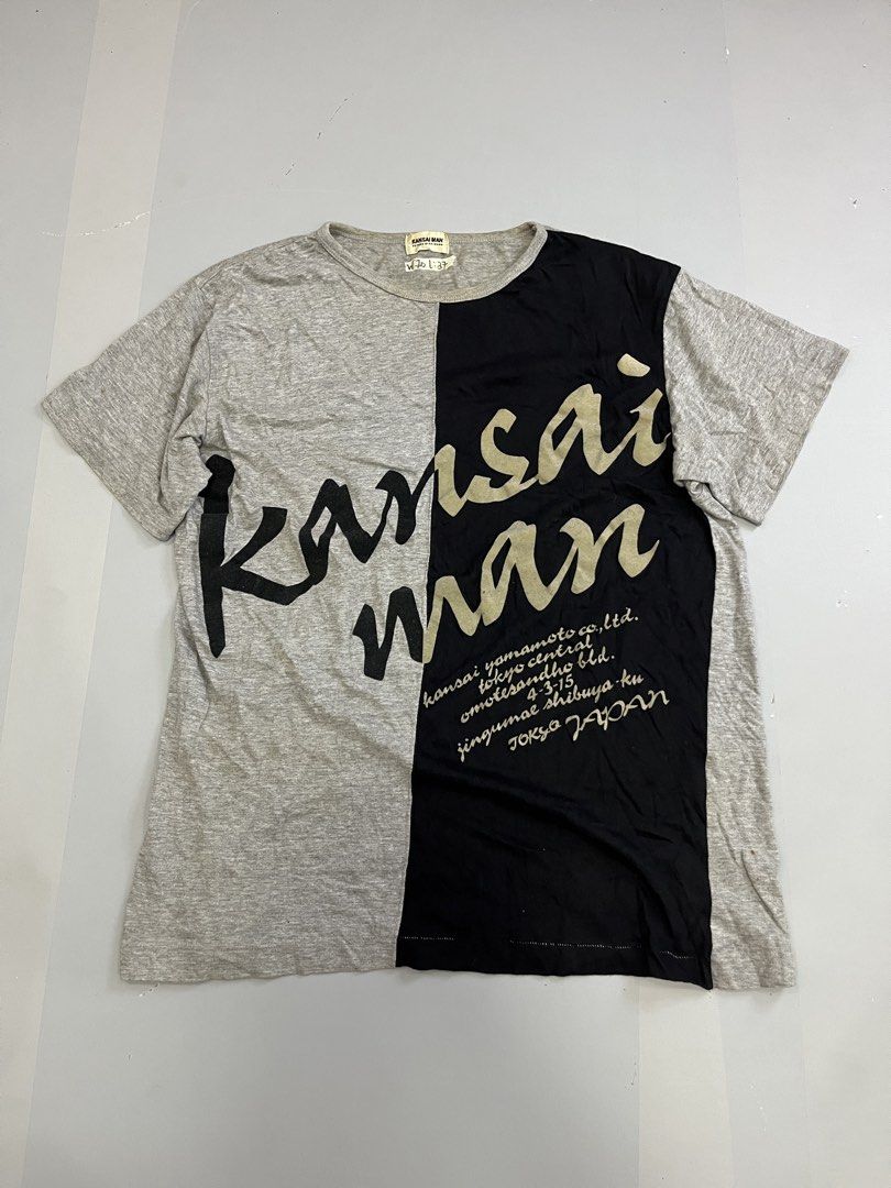 Kansai Man Yamamoto T-shirt Grey Black Split Design (Category: Tshirts & Polo Shirts ) located in Mabalacat. Submitted by aas_thriftfings (Listing ID 1461516613, Image 1). Description: - Authentic Kansai Man t-shirt - Striking grey and black split design - Bold 'Kansai Man' graphic - Features brand's Tokyo address detail - Comfortable cotton blend fabric - Size L (check measurements for best fit) - Ideal statement piece for streetwear enthusiasts