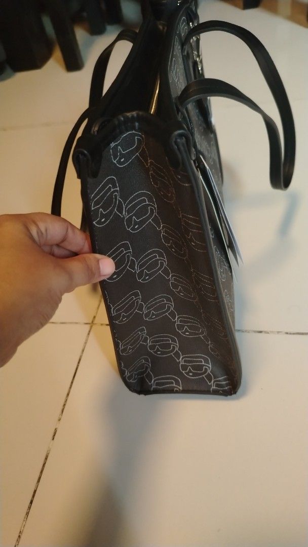 Karl Lagerfeld Monogram Tote Bag with Cat Charm (Category: Tote Bags) located in Manila. Submitted by wildwind_73f77a (Listing ID 1461485697, Image 3). Description: - Authentic Karl Lagerfeld tote bag - Features all-over Karl Lagerfeld monogram print - Comes with a cute cat charm - Secure zipper closure - Durable leather trim and handles - Ideal for everyday use - Spacious interior.