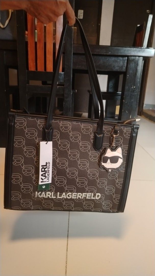 Karl Lagerfeld Monogram Tote Bag with Cat Charm (Category: Tote Bags) located in Manila. Submitted by wildwind_73f77a (Listing ID 1461485697, Image 1). Description: - Authentic Karl Lagerfeld tote bag - Features all-over Karl Lagerfeld monogram print - Comes with a cute cat charm - Secure zipper closure - Durable leather trim and handles - Ideal for everyday use - Spacious interior.