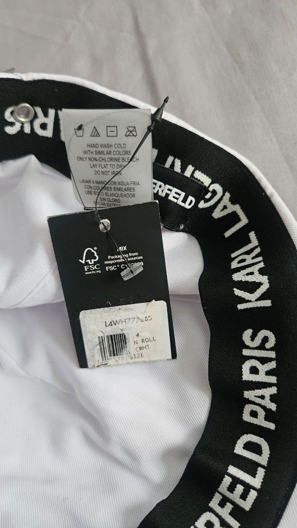 Karl Lagerfeld White Cap with Charms (Category: Hats & Beanies) located in Rizal. Submitted by vanbdc24 (Listing ID 1461379525, Image 3). Description: - bought $120 authentic Karl Lagerfeld cap - Features unique charms: sunglasses, guitar, tie - Adjustable strap for a perfect fit - Interior black band with Karl Lagerfeld branding - Adds a stylish flair to any outfit.