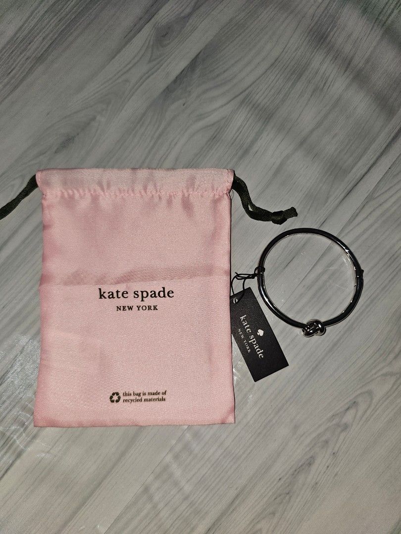 Kate Spade New York Knot Bangle Bracelet Silver (Category: Bracelets) located in Manila. Submitted by tokyo_thv (Listing ID 1461340832, Image 1). Description: - Brand: Kate Spade New York - Item: Knot Bangle - Material: Silver tone metal - Condition: New (with original tag) - Includes: Original pink dust bag and tag - Tag Value: CAD $89.00 - Style: Chic and elegant accessory.