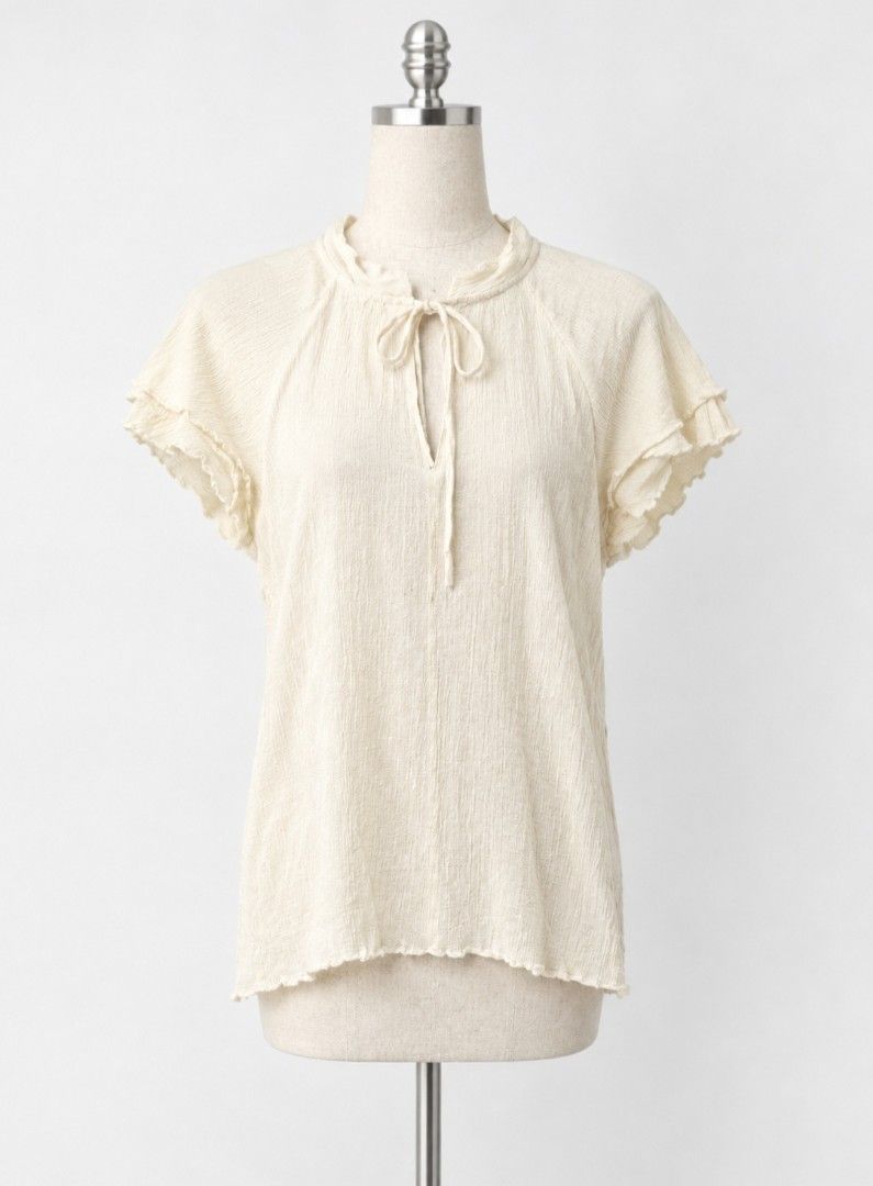 Key Hole Cream Textured Tie-Neck Flutter Sleeve Blouse (Category: Blouses) located in Cabanatuan. Submitted by riworks (Listing ID 1461491021, Image 1). Description: - Have small stain - Cream colored blouse - Textured fabric - Tie-neck detail - Flutter sleeves - Keyhole neckline opening - Slightly ruffled.
